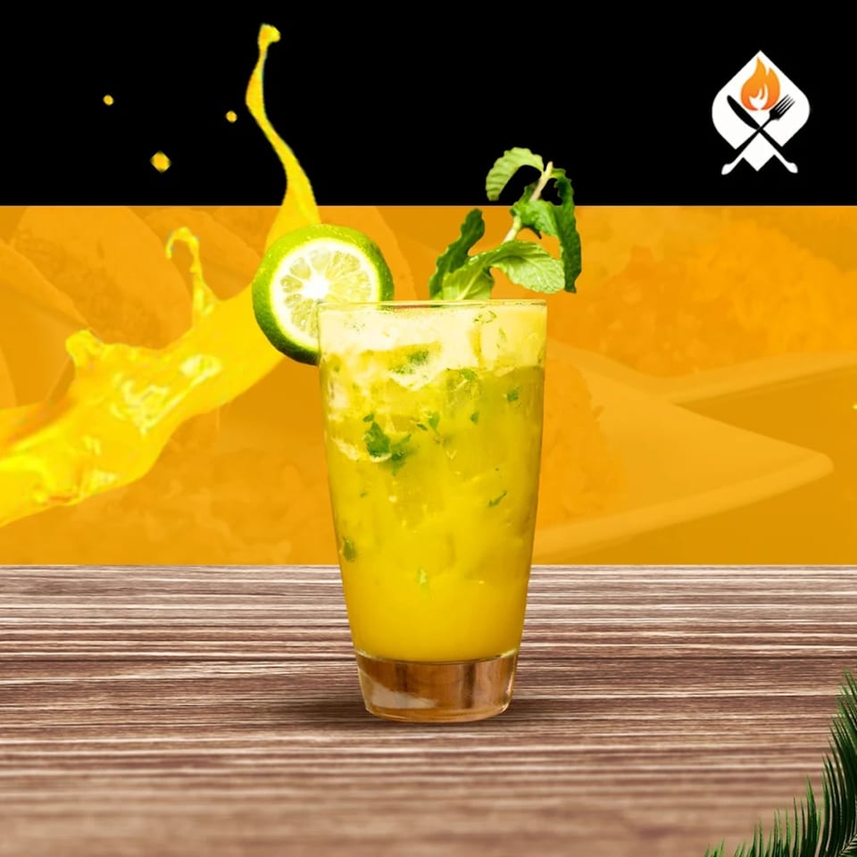 Refreshing yellow drink with lime and mint on a wooden table, with a Mexican restaurant logo.