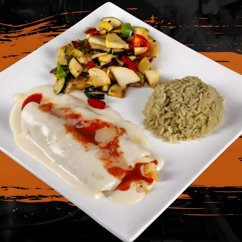 Mexican enchiladas with white sauce and red drizzle, served with rice and sautéed vegetables.