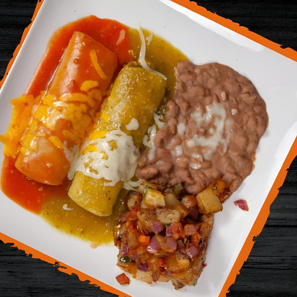 Two enchiladas, one red and one green, with refried beans and diced potatoes on a white plate.
